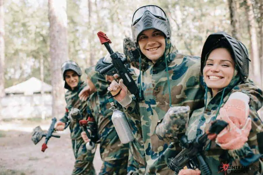 Friends having fun while playing paintball.